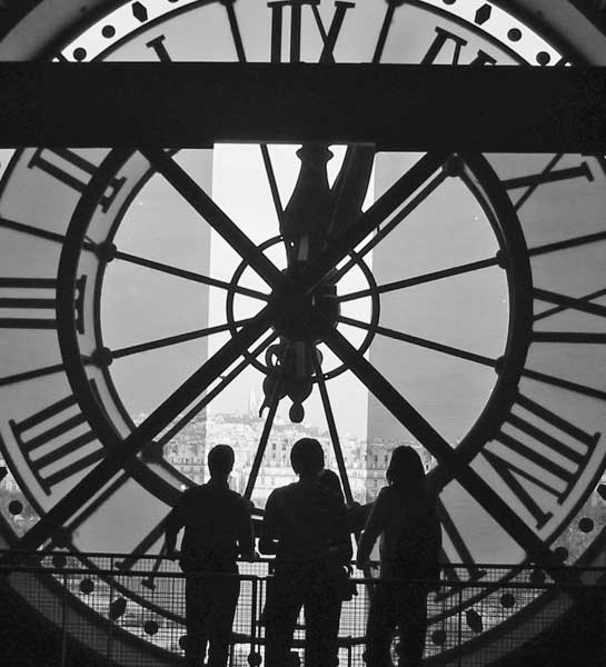 Three figures with clock in background