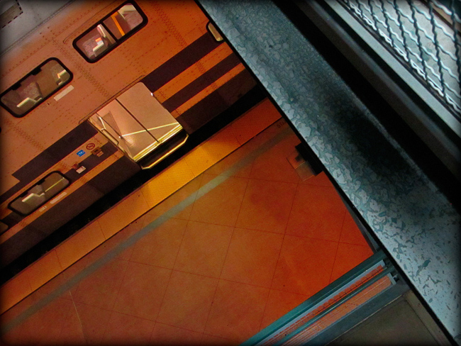 Diagonal abstract shot of train in station and pedestrian walkway