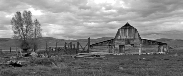 Lonely looking abandoned barn with stomy sky