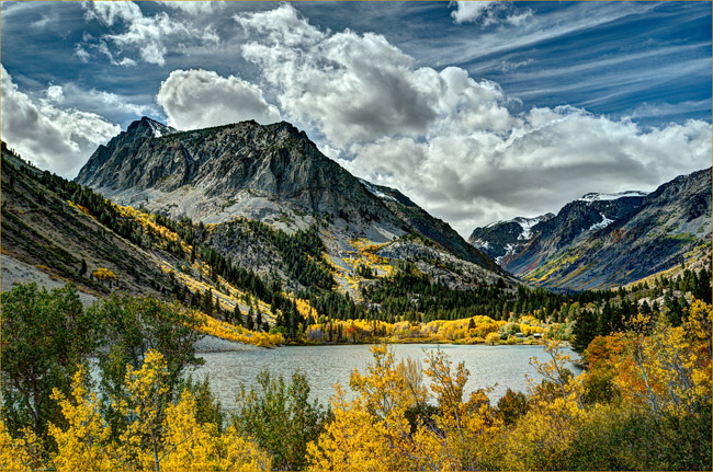 Clouds over Mountains, Lake, and Golden Trees
