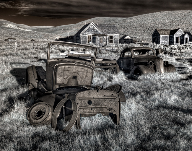 Rusted Cars in Foreground with Shacks in Background
