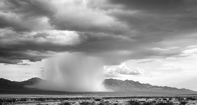 Rain spout in front of mountain range