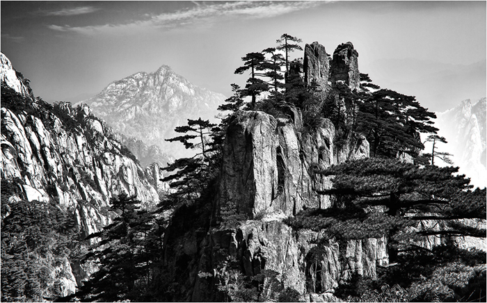 Yellow Mountain in Foreground with Fog-Shrouded Mountains in Background