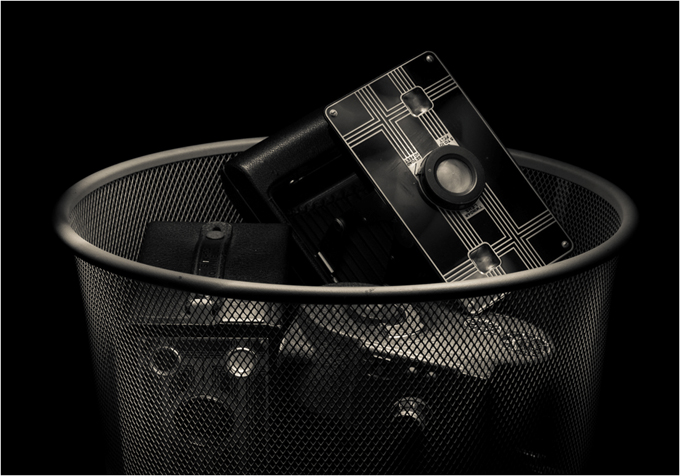 Old Cameras in a Mesh Trash Can